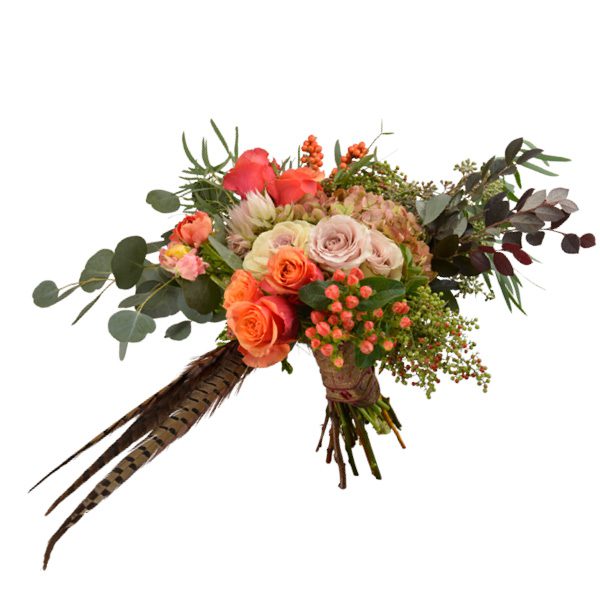 Fall bouquet with antique hydrangeas, bridal protea, seeded eucalyptus, pepper and ilex berries, champagne roses, ranunculus and pheasant feathers. Ted and Debbie’s Flower and Garden, Tulsa.